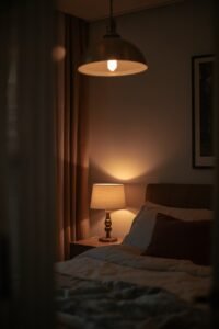 Warmly lit bedroom with a bedside lamp and cozy bedding, part of master bedroom makeover ideas.